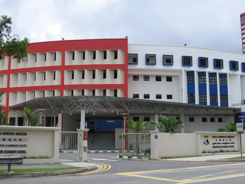 Front gate of Anderson Secondary School in Ang Mo Kio, with the school's name signs in four languages and its red and white blocks behind a covered drop-off