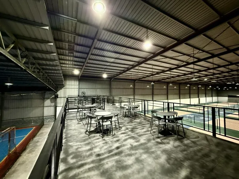 Indoor hall at Athlon Sports Centre with a seating mezzanine overlooking the pickleball courts